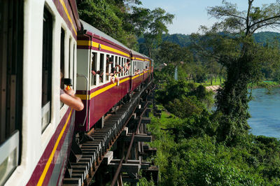 Kanchanaburi, thailand - october 31, 2019 crowd of passengers takes picture during train trip