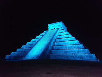 Low angle view of staircase against clear blue sky at night