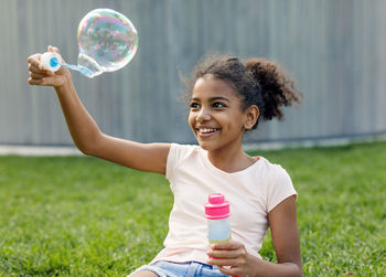 Portrait of a girl holding bubbles