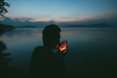 Scenic view of lake at sunset