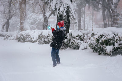 People walking on city street covered in snow during heavy snowfall. storm filomena in madrid. 