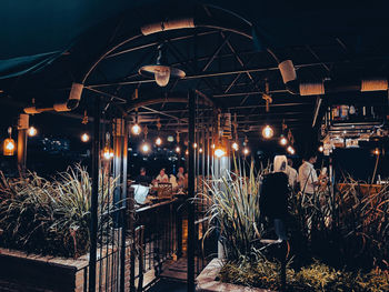 Illuminated restaurant by building at night