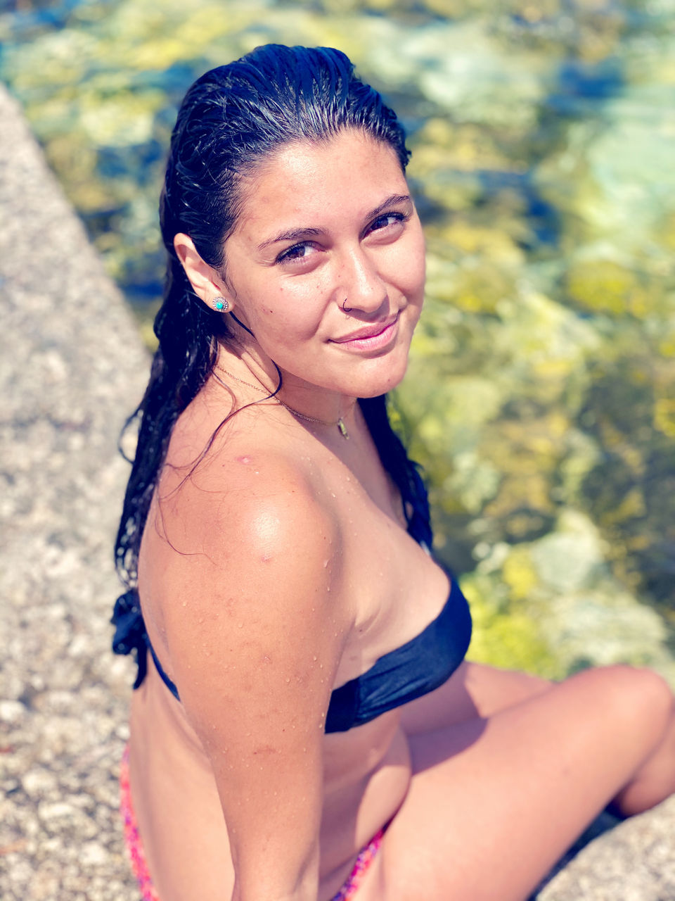 women, one person, adult, portrait, clothing, swimwear, smiling, young adult, bikini, looking at camera, summer, happiness, nature, hairstyle, water, lifestyles, female, emotion, relaxation, leisure activity, trip, black hair, vacation, photo shoot, land, holiday, sunlight, person, human hair, long hair, human leg, outdoors, day, fashion, cheerful, beach, limb, three quarter length, swimsuit top, brown hair, enjoyment, sun, focus on foreground, teeth, sitting, smile, swimming, undergarment, wet, child