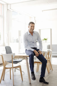 Portrait of smiling businessman in office