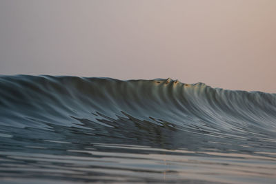 Close-up of water flowing against clear sky