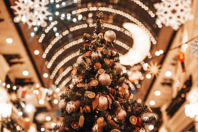 Christmas tree decorated with dried oranges, mandarins, pine cones and golden shiny christmas balls