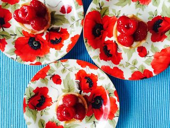 Close-up of raspberry pastry on a colorful poppy patterned plates