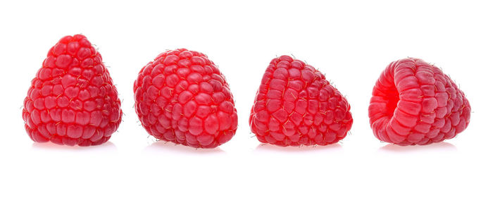 Close-up of raspberries on white background