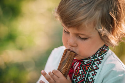 Boy playing musical instrument