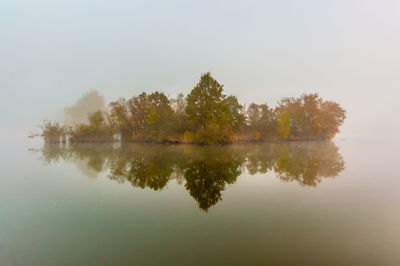 Reflection of trees in lake against sky