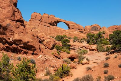 Rock formations on landscape against clear sky