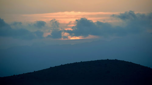 Scenic view of silhouette mountain against sky during sunset