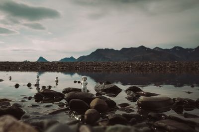 Scenic view of lake against cloudy sky