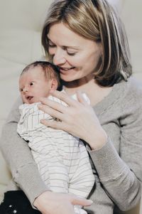 Mother embracing baby at home