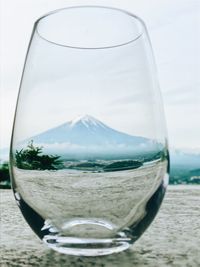 Close-up of beer in water against sky