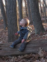 Side view of boy in forest