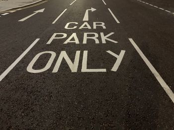 High angle view of arrow sign on road in city