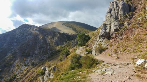 Scenic view of mountains against cloudy sky