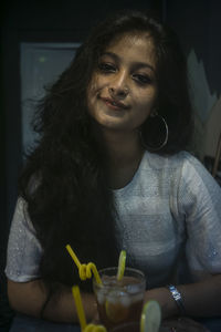 Portrait of a young woman drinking drink