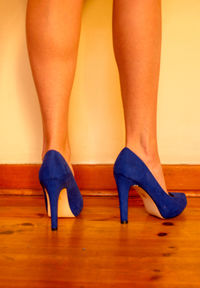 Low section of woman wearing high heels