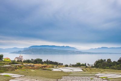 Scenic view of mountains against cloudy sky
