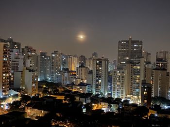 High angle view of illuminated buildings against sky at night