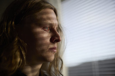 View of woman looking through window