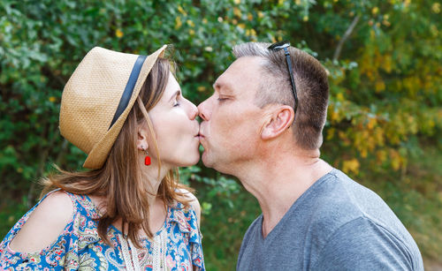 Portrait of couple kissing outdoors