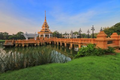 Exterior of temple by building against sky