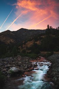 Scenic view of river against sky during sunset