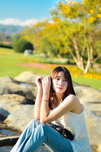 Young woman sitting on rock