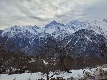 Scenic view of snowcapped mountains against sky