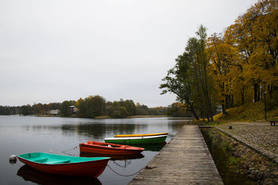 Old wooden boats near the beach of trakai gavle lake, lithuania. autumn and fall time.