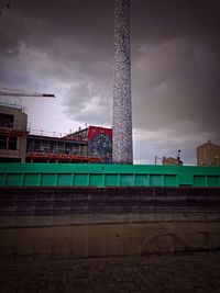 Low angle view of buildings against cloudy sky