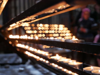 Close-up of lit candles in temple