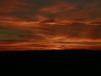 Silhouette of landscape against dramatic sky