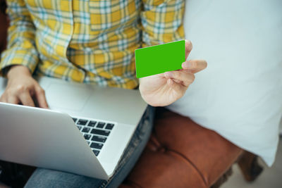 Midsection of man using mobile phone