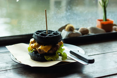 Close-up of hamburger served in plate on table