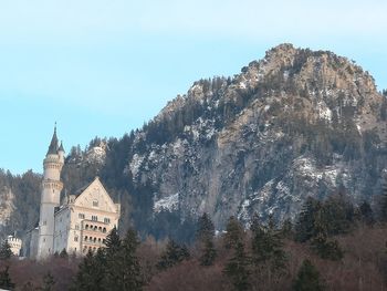 Panoramic view of neuschwanstein castle and mountains against sky