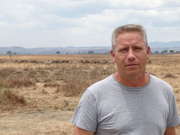 Portrait of man on field against sky