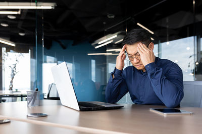 Businesswoman using laptop at office