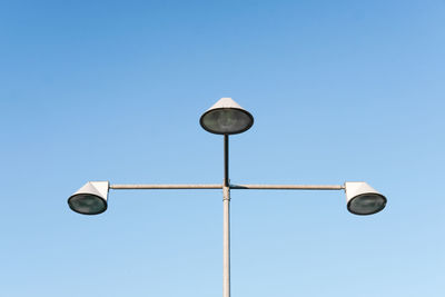 Low angle view of street light against clear blue sky