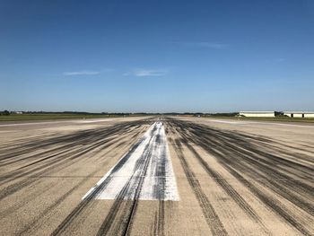 Road passing through airport against sky