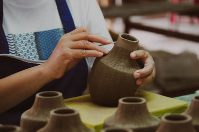 Midsection of man working on table