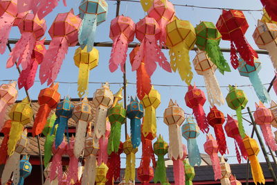 Low angle view of lanterns hanging against sky