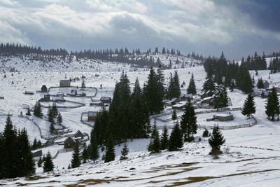 Snow covered landscape against sky