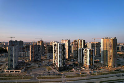 Aerial view of modern buildings in city against clear sky