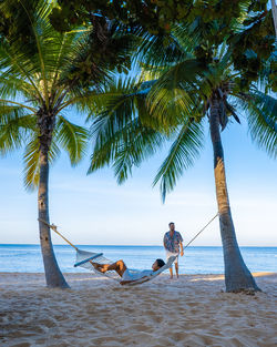 People on beach against sky