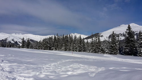 Snow covered landscape against sky