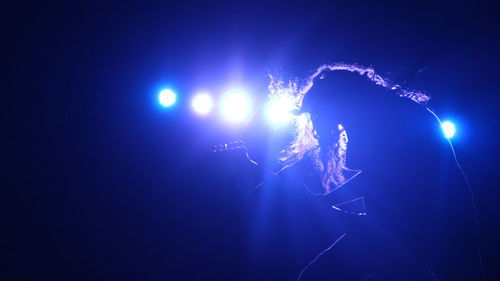 Low angle view of fireworks display at night